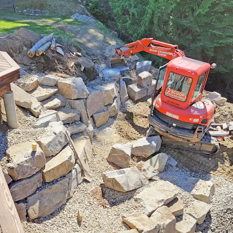 Rock retaining wall on steep mountain bank in Nelson BC. 